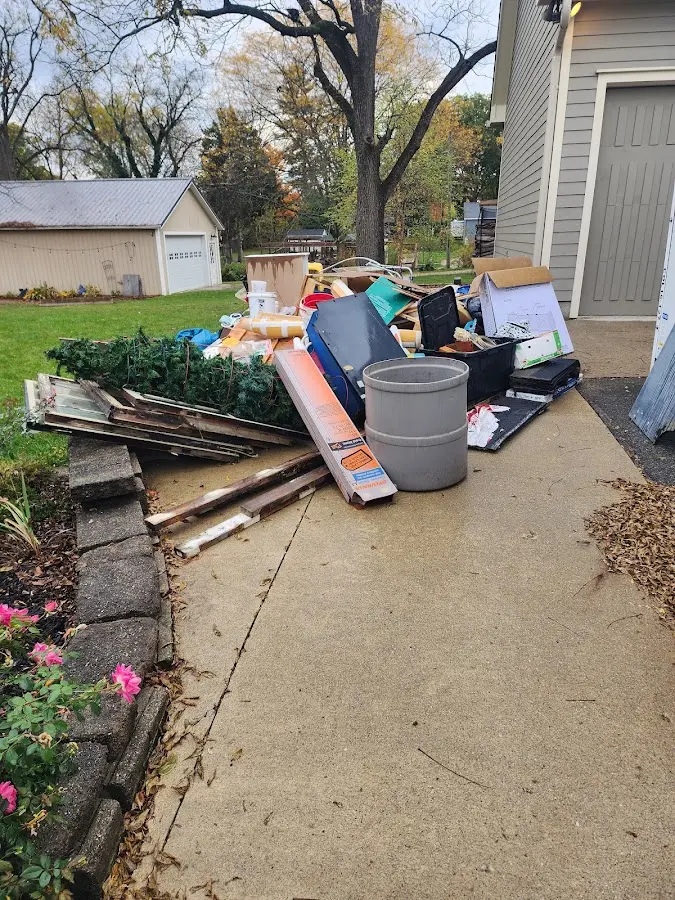 Dumpster being loaded with debris for Residential Dumpster Rental in Green